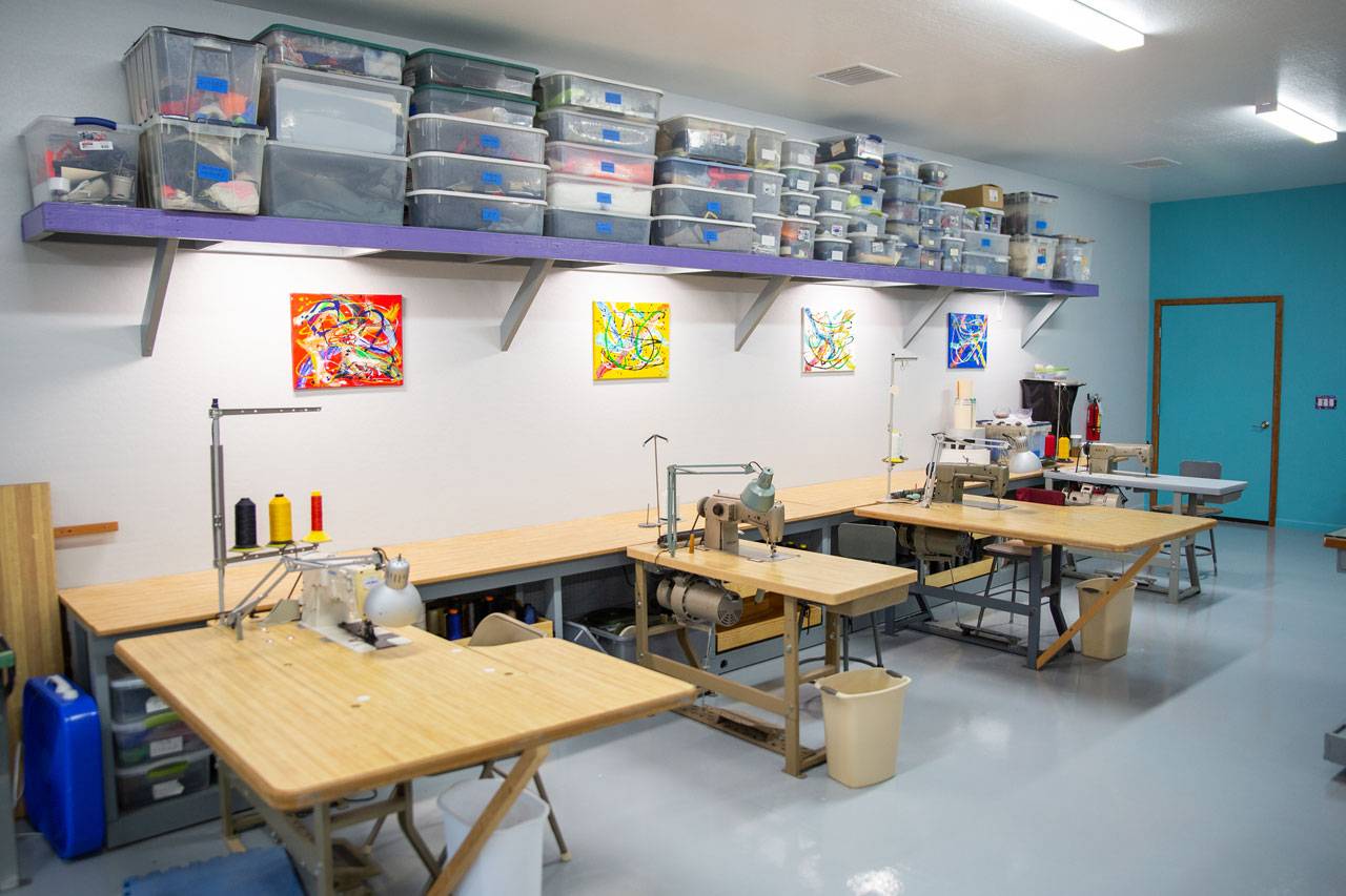 Row of sewing machine stations for parachute repair at USAPR in Eloy, AZ