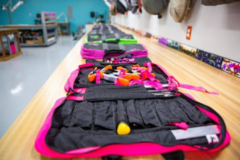 Parachute packing table with multi-color rigging kits lined up at USAPR in Eloy, AZ